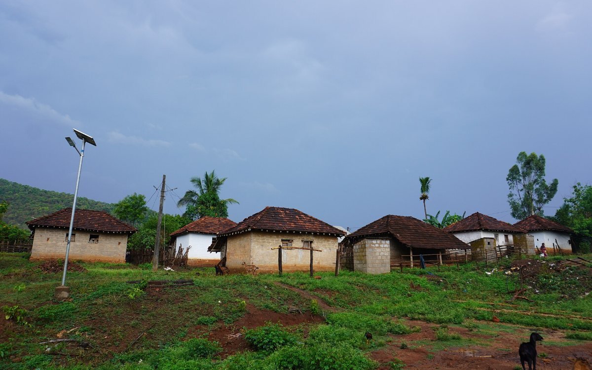 Solar energy in a village: a solar street light beside tiled-roof houses in a tribal village in Andhra Pradesh, India (representative image)