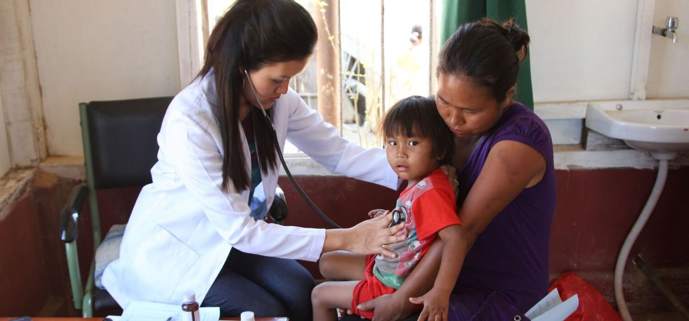 A doctor examines a young child held by her mother at a free government health camp in India (representative image)
