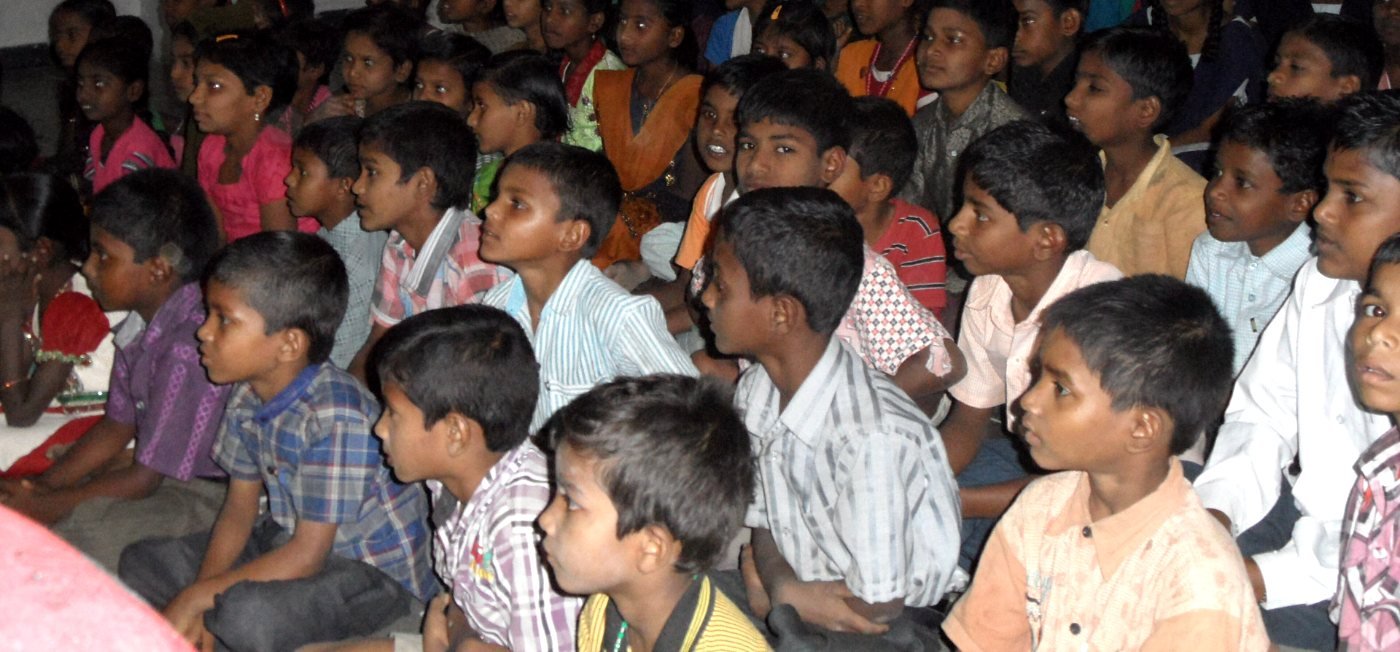 Children seated together listening in a village school in Andhra Pradesh, India (representative image)